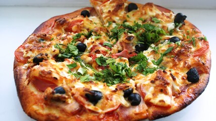 fresh pizza on a plate on the windowsill