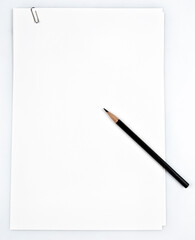 white paper with pencil and paper clip