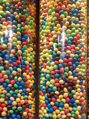 Fototapeta na wymiar Colourful sweets and candy in glass tube display.