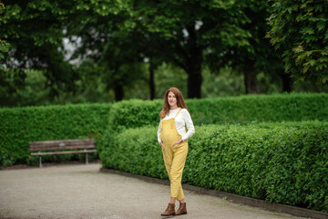 Beautiful pregnant girl walking in the Park.