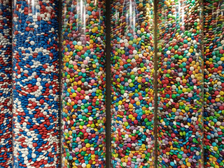 Colourful sweets and candy in glass tube display.