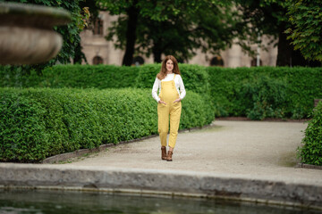 Beautiful pregnant girl walking in the Park.