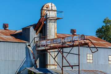 Old grain mill rusting away slowly as it has become outdated. © Erich Grant