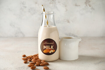 Tasty almond milk on light background