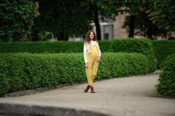 Beautiful pregnant girl walking in the Park.