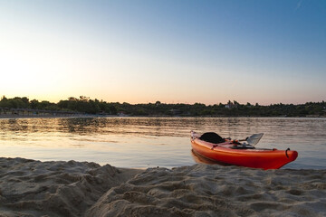 Fototapeta premium Kayaks arranged on the beach in Greece in hot summer day. Best hobby for the summer vacation