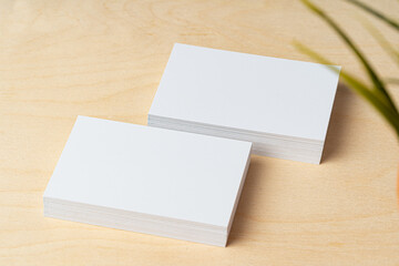 Two piles of blank business cards on table