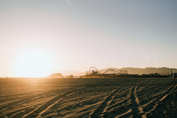 beach landscape with Ferris wheel in the sunset
