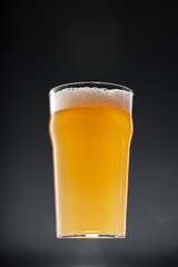Glass of beer on black background, copy space