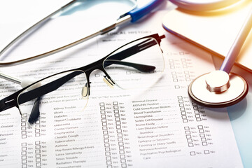 Medical, healthcare and telemedicine concept. Close up image of a medical history form and doctors...