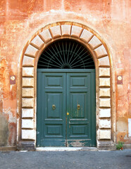 Fototapeta na wymiar Old wooden door of a vintage house in Trastevere, Rome