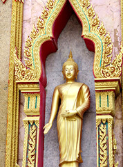 Fototapeta premium Close up of the golden statue of Buddha in a temple of Chalong in Phuket Thailand