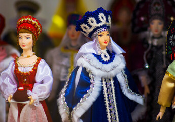 Beautiful vintage colourful wooden dymkovo dolls at market. Dymkovo dolls is folks cultural symbol of Russia. With selective focus on one doll