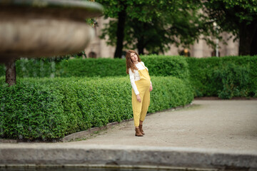 Beautiful pregnant girl walking in the Park.