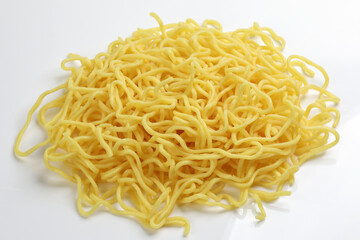 Fresh yellow egg noodle on whit background