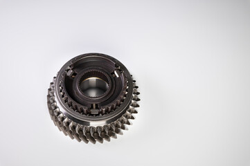 A new gear part on a gray background. The concept of new parts and spare parts