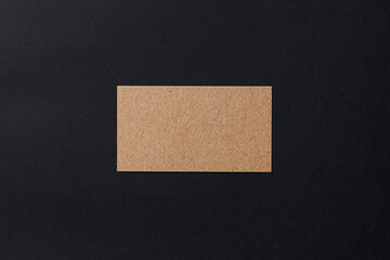 Business card of a craft paper on black background