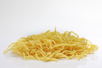 Fresh yellow egg noodle on whit background