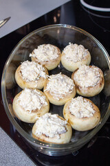 Stuffed mushrooms stuffed with cheese, mushroom stalks and onions. In a baking dish.