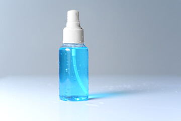 Spray bottle of blue alcohol 70% isolated on white background, Spraying Antivirus, Sanitizer Spray, Hand Sanitizer Dispenser, infection control concept. Sanitizer to prevent Coronavirus or Covid-19. 