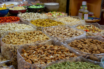 Cashew and Pistachio Nuts prepared and seasoned a variety of ways available at an open market (selective focus)