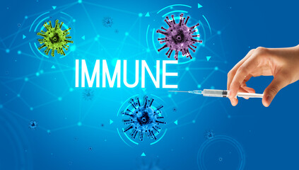 Syringe, medical injection in hand with IMMUNE inscription, coronavirus vaccine concept