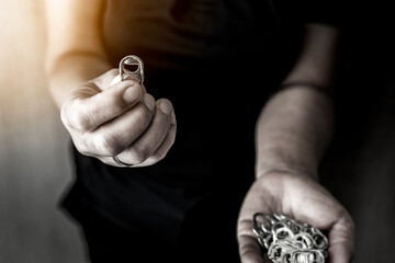Fototapeta premium Hand holding stack of ring pull aluminum of cap cans.Raw materials for prosthetics and prosthetics for the disabled concept.