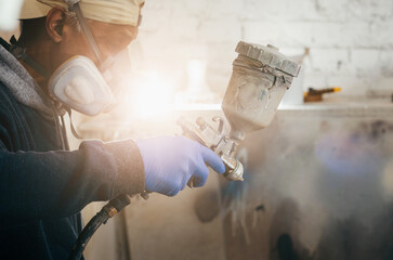 Master painter in a factory, industrial painting  wood with spray gun. 