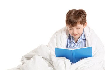 Little boy wrapped in blanket reading book on white background