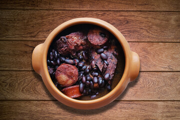 Feijoada. Traditional Brazilian food. Isolated on wooden background.