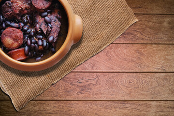 Feijoada. Traditional Brazilian food. Isolated on wooden background.