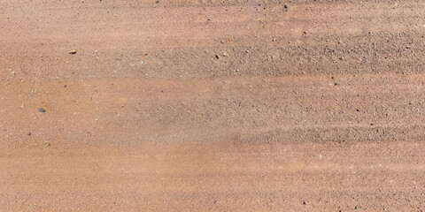 view from above on texture of gravel road with car tire tracks