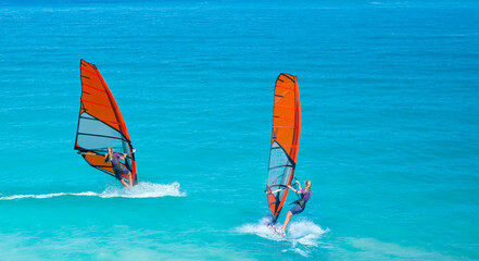 Beautiful cloudy sky with Windsurfer Surfing The Wind On Waves In Alacati - Cesme, Turkey 