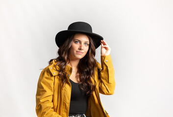 Fototapeta premium Beautiful Young Model posing in dress and hat on white background 