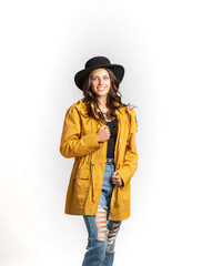 Fototapeta premium Beautiful Young Model posing in dress and hat on white background 