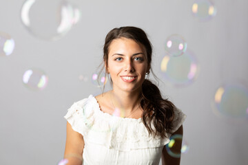 Beautiful young model with bubble in the air.