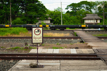 railroad crossing in the park with non smoking sign