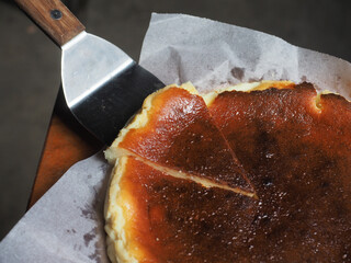 Basque burnt cheesecake on triangular spatula