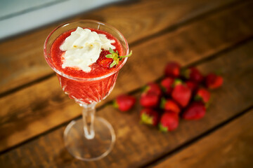 cocktail with fresh strawberries on an old rustic table