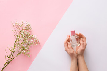 Female hands with perfume and flowers on color background - obrazy, fototapety, plakaty