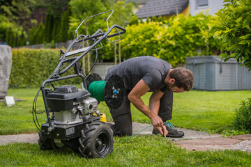 Cable laying machine with an operator used to put down cables for robotic lawnmowers. Inserting...