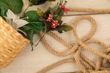 old rope and flower on the wooden background