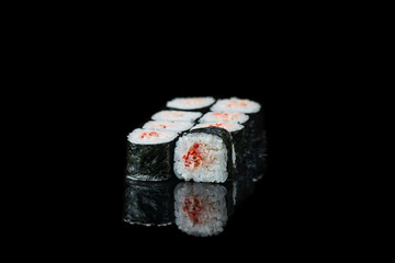 Sushi Roll On A Black Background reflection . Japanese food. Close Up.