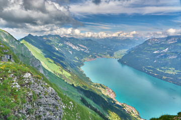Panorama landscape of Swiss Alps with mountains, meadows and Lake Brienz. Taken at Hardergrat ridge...