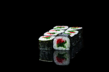 Sushi Roll On A Black Background reflection . Japanese food. Close Up.