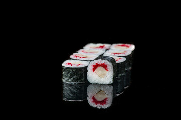 Sushi Roll On A Black Background reflection . Japanese food. Close Up.