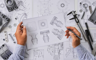 Engineer technician designing drawings mechanical parts engineering Engine.manufacturing factory...