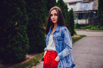 Gorgeous female dressed in jacket strolling on street.Portrait of young woman in trendy clothing