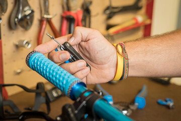 Lock on bicycle grips waiting to be installed on handlebars. Hands of a person seen holding grips to be installed on a bicycle
