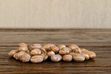 few grains of beans on wooden table